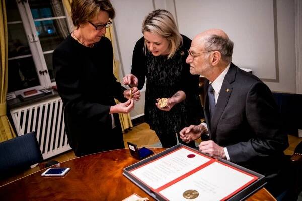 A man looks at medal