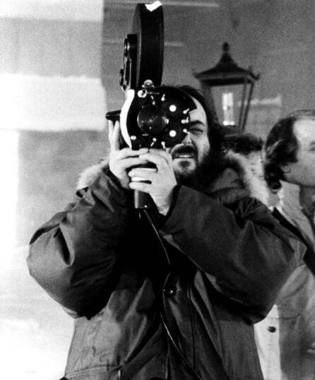 THE SHINING, Director Stanley Kubrick checks a camera set-upm 1980