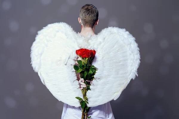 Inspired, romantic man-angel with a bouquet of red roses. Valentine's day. Love concept. Naked boy stock images, royalty-free photos and pictures
