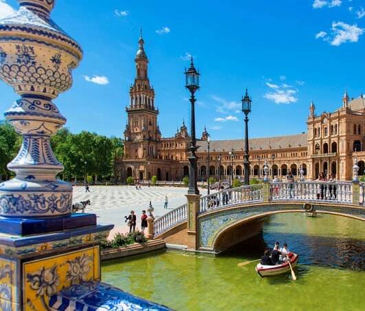 Plaza de Espana and boat on canal in Seville, Spain.