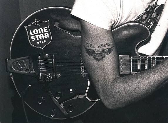 Ray Benson's arm over a guitar with an 