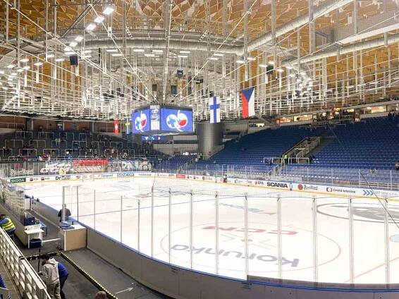 The inside of the Winning Group Arena in Brno, Czech Republic with blue seating and an ice rink below