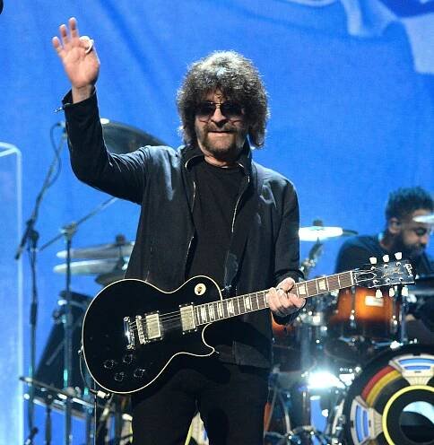 Jeff Lynne of ELO performing onstage with a guitar.