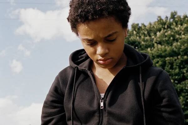 Nykiya Adams looks down in a still from Bird, the film this interview is about