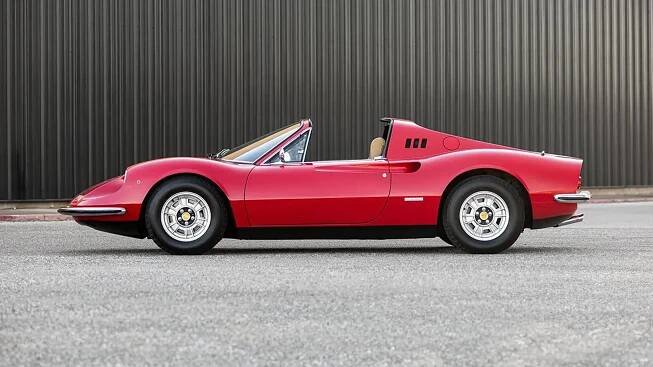 a red sports car is parked in front of a building