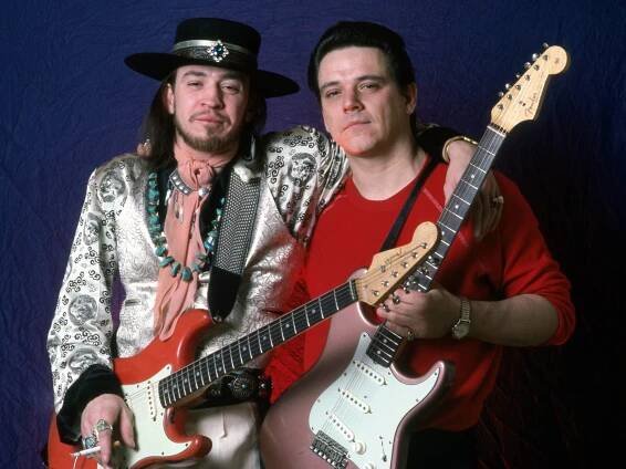 Stevie Ray and Jimmie Vaughan, posing with Strats in hand.