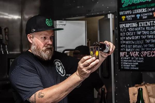 Beer Zombies founder Chris Jacobs pouring a beer at the original Draft Room & Bottle Shop.