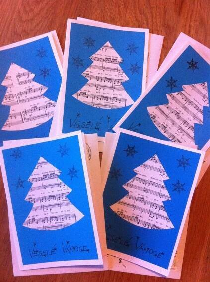 four christmas cards with sheet music on them, all decorated in blue and white paper