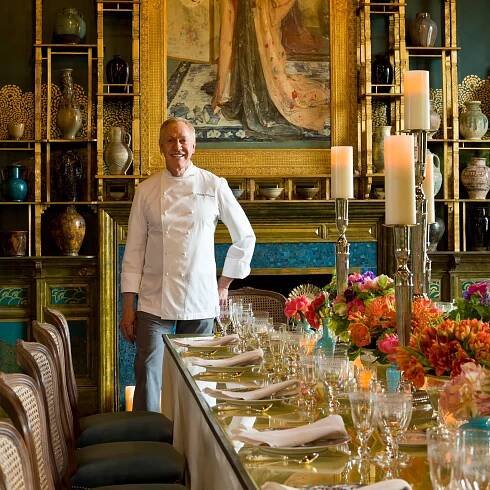 Chef Patrick O'Connell standing by a table with place settings.