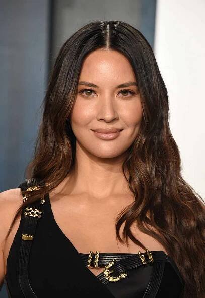 Olivia Munn long, glossy dark brown hair with subtle balayage
