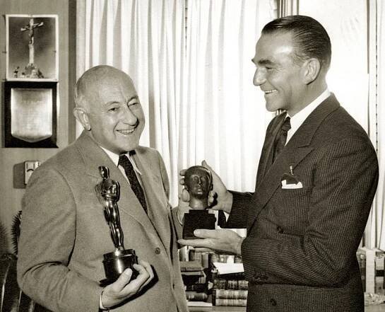 Henry Wilcoxon congratulates Cecil B. DeMille