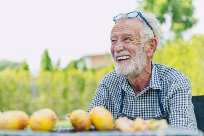 elderly man smiling brightly with nice teeth, full-mouth dental implants
