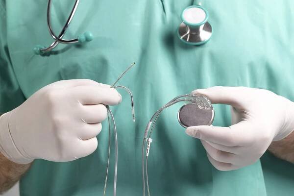 Doctor holds a pacemaker