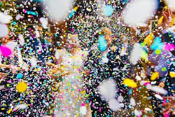 Couple lost in a cloud of colourful confetti