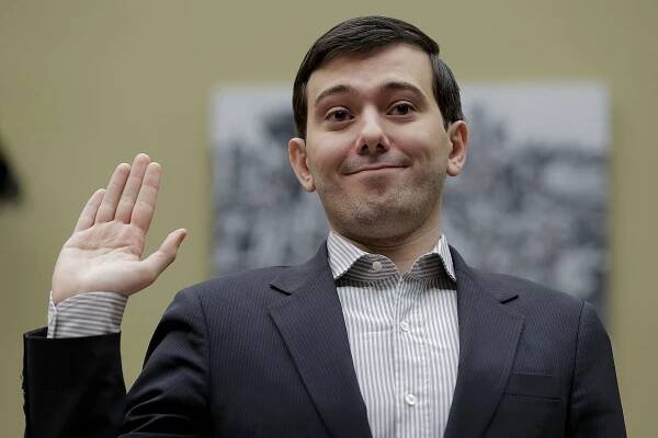 Martin Shkreli waves outside the Capitol in Washington.