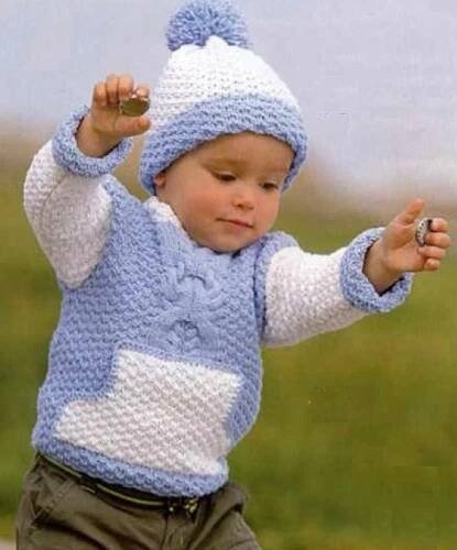 a small child wearing a blue and white knitted hat