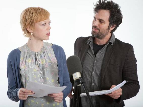 Emily Bergl and Mark Ruffalo hold scripts and look at each other whilst speaking in to a microphone during performance of the audio play Awake and Sing by Clifford Odets