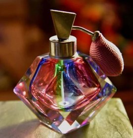 A Small Bottle Of Perfume With A Pink And Purple Lid Wallpaper