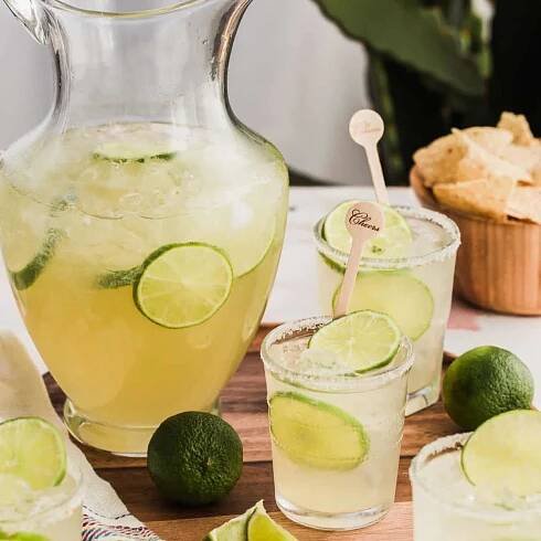 easy beer margarita recipe with full pitcher and filled glasses.