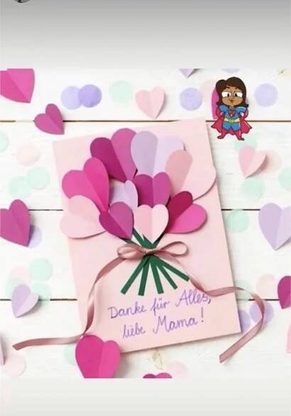 a card with pink flowers and hearts on it