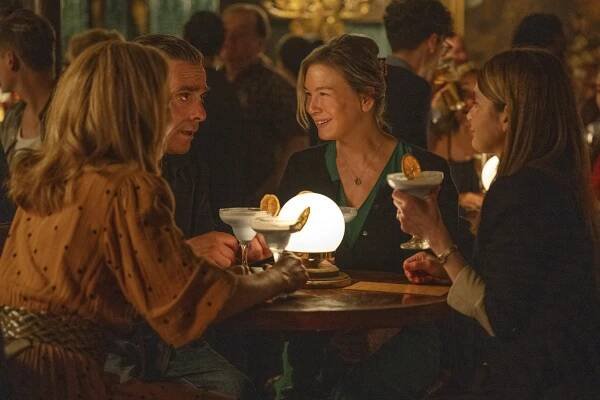 This image released by Universal Pictures shows, from left, Sally Phillips, James Callis, Renée Zellweger, and Shirley Henderson in a scene from "Bridget Jones: Mad About the Boy." (Jay Maidment/Universal Pictures via AP)