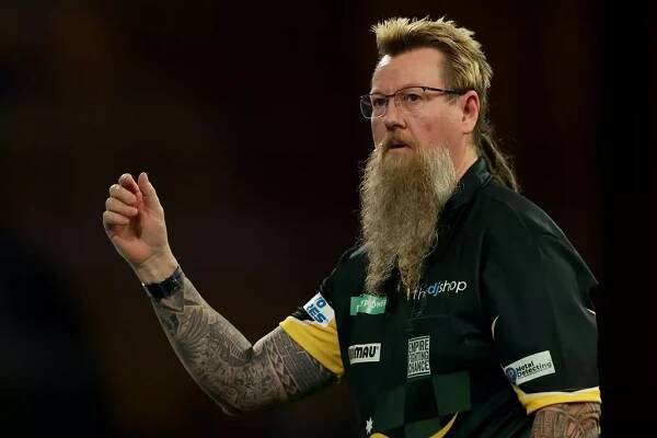 LONDON, ENGLAND - DECEMBER 15: Simon Whitlock of Australia reacts in his first round match against Paolo Nebrida of the Philippines on Day One of 2023/24 Paddy Power World Darts Championship at Alexandra Palace on December 15, 2023 in London, England. 