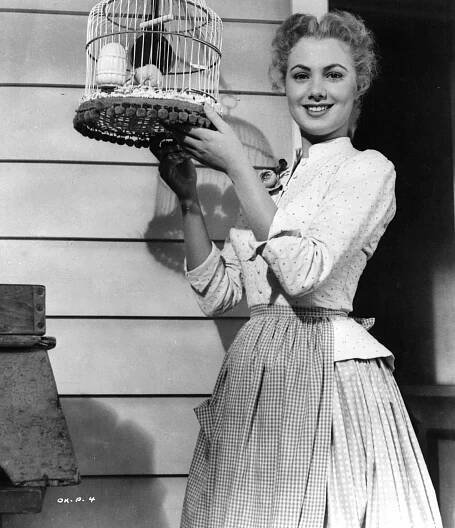 Shirley Jones holding birdcage in a scene from the film 'Oklahoma!', 1955. 