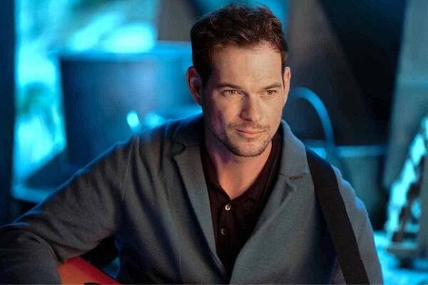 Brad Abramenko playing guitar during a scene in Hallmark's 