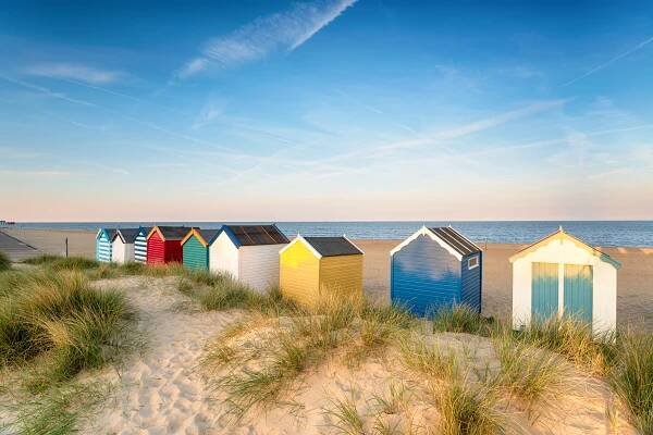 A row of colourful beach huts in Southwold, site of one of the best scenic drives near London