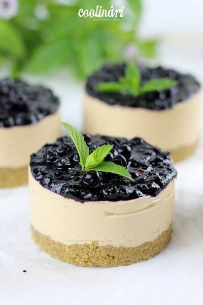 four small desserts with blueberries and mint sprigs