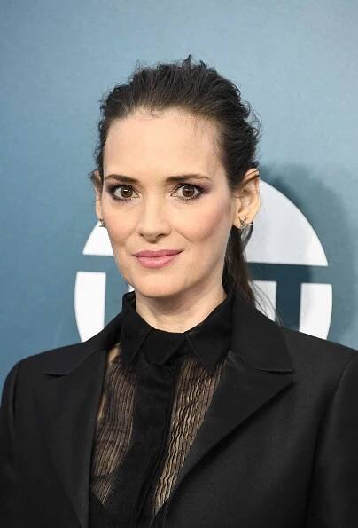 Winona Ryder tousled updo with eyeliner and a light pink lip