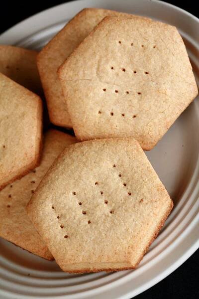 A plate of hexagonal gluten free shortbread cookies.
