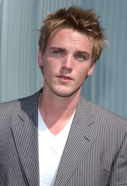 short spiky hair wearing a blazer