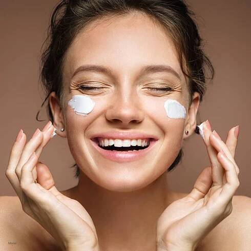 Woman with lotion on face