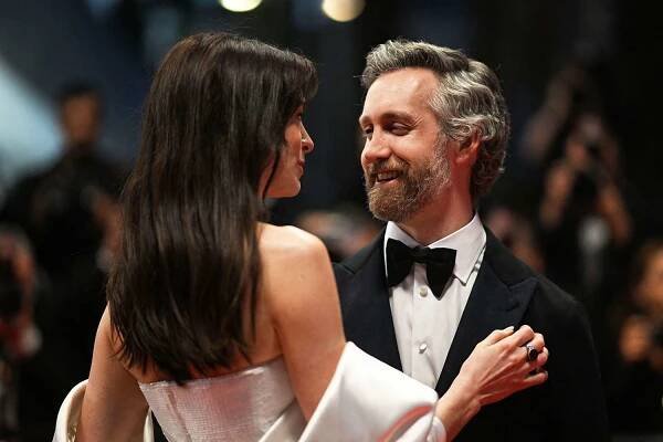 Anne Hathaway and her husband Adam Shulman leave the Festival Palace following the screening of the film "Armageddon Time" during the 75th edition of the Cannes Film Festival in Cannes, southern France on May 19, 2022.