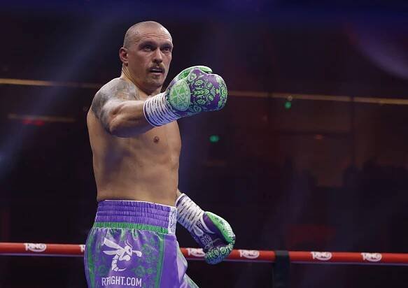 Oleksandr Usyk reacting during a boxing match.