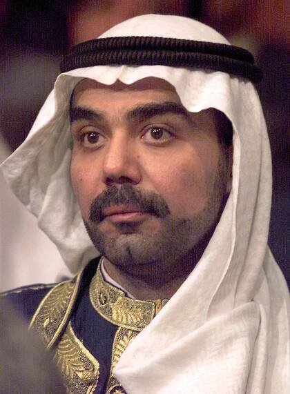 Saddam Hussein's eldest son Uday (R) attends a Par