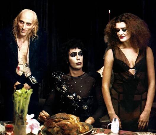 Scene from The Rocky Horror Picture Show (1975) featuring Richard O'Brien, Tim Curry, and Patricia Quinn.