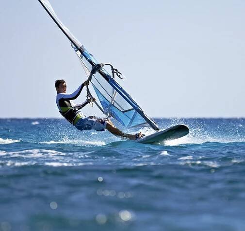 A person windsurfing in the ocean
