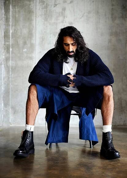 Amar wears ribbed wool cardigan by CONNOLLY. T shirt by ALL SAINTS. Shorts by 