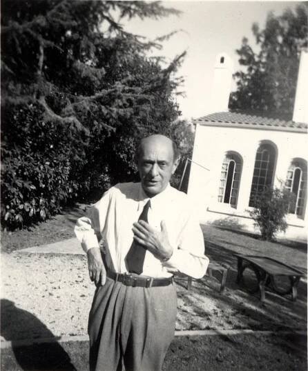 Arnold Schoenberg stands outside his home.