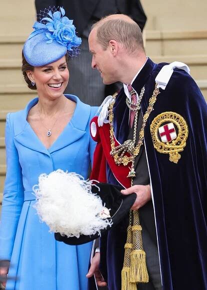 Prince William and Kate Middleton smiling at each other.