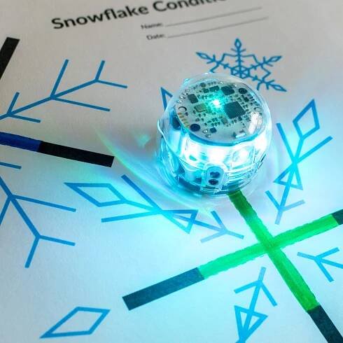A picture of the Snowflake Conditionals STEM activity. Students use Ozobot to detect the color of each snowflake.