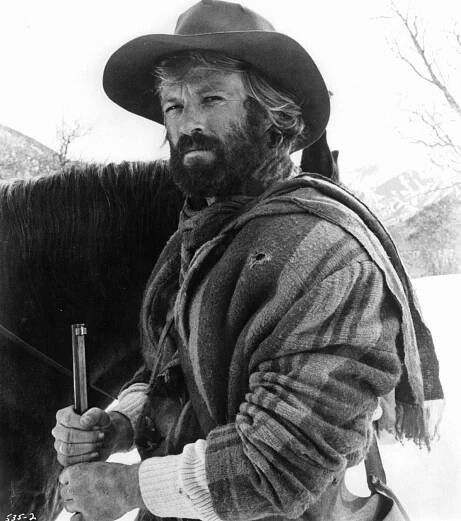 Robert Redford With A Full Beard Wearing Thick Winter Clothing In A Scene From 'Jeremiah Johnson', 1972.