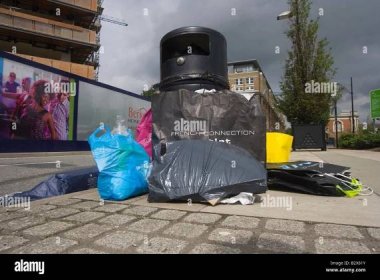 Overflowing rubbish bins with designer bags and packaging Stock Photo ...
