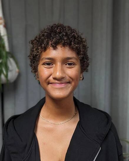 17. Curly Charm: Effortlessly Bold with Playful Bangs
