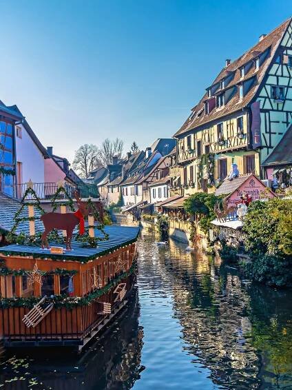 Houses along a canal in Colmar decorated for Christmas