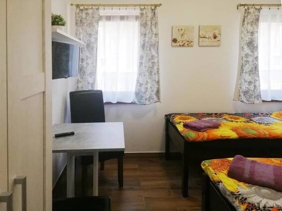 Kama o mga kama sa kuwarto sa Apartmány Aranka