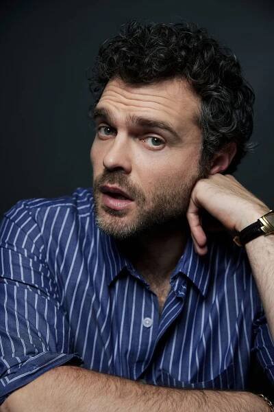 Image may contain Alden Ehrenreich Face Head Person Photography Portrait Wristwatch Adult Black Hair and Hair