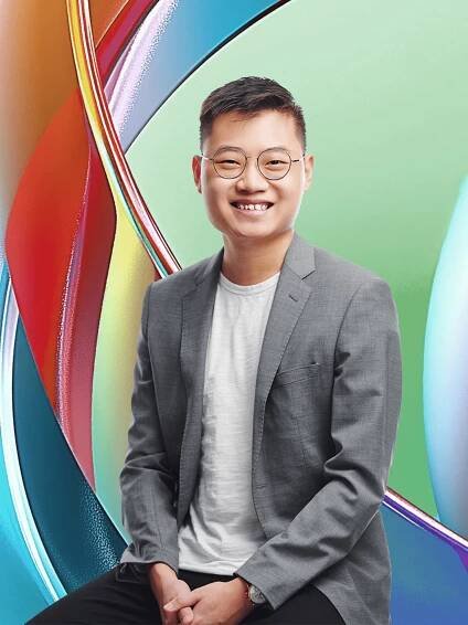 a young man smiling at the camera